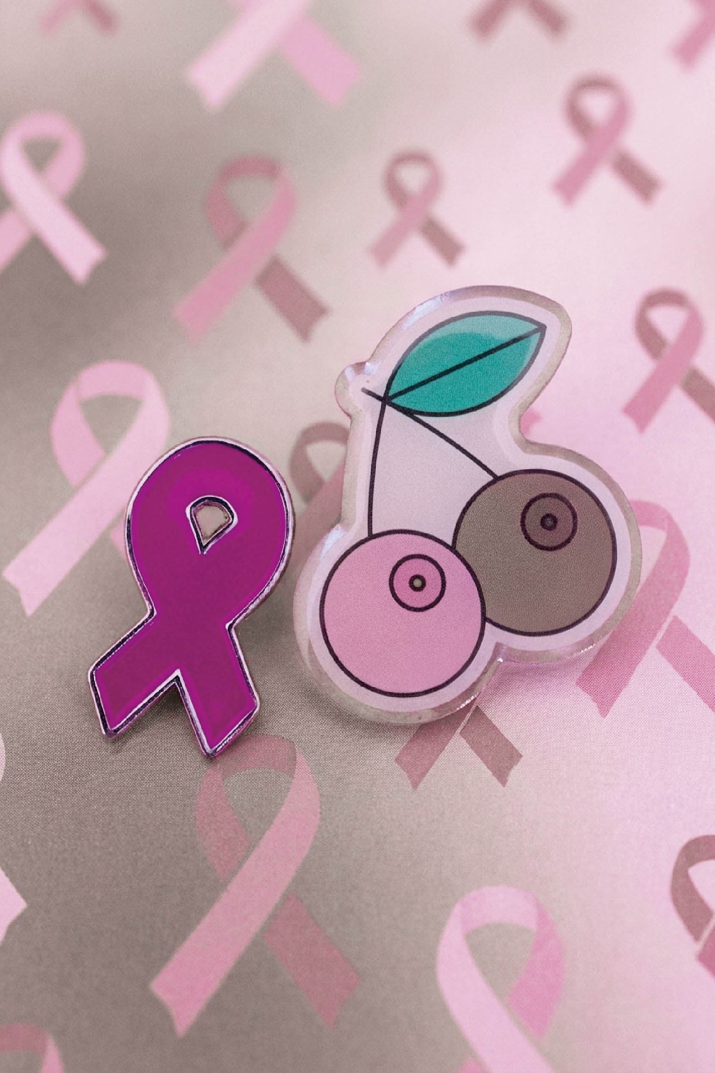 Brustkrebs Awareness-Pins vor rosa Hintergrund